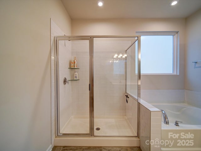 bathroom featuring separate shower and tub