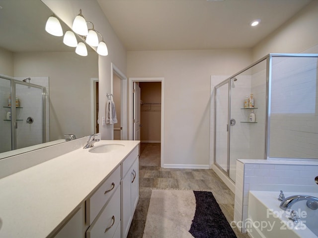 bathroom with shower with separate bathtub and vanity