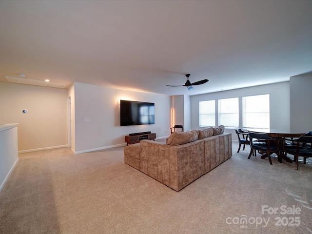 carpeted living room featuring ceiling fan