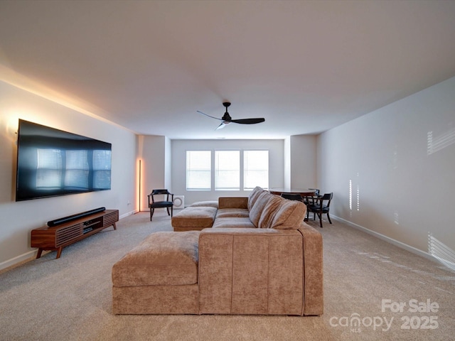 carpeted living room featuring ceiling fan