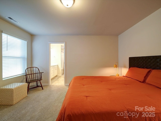 carpeted bedroom featuring connected bathroom