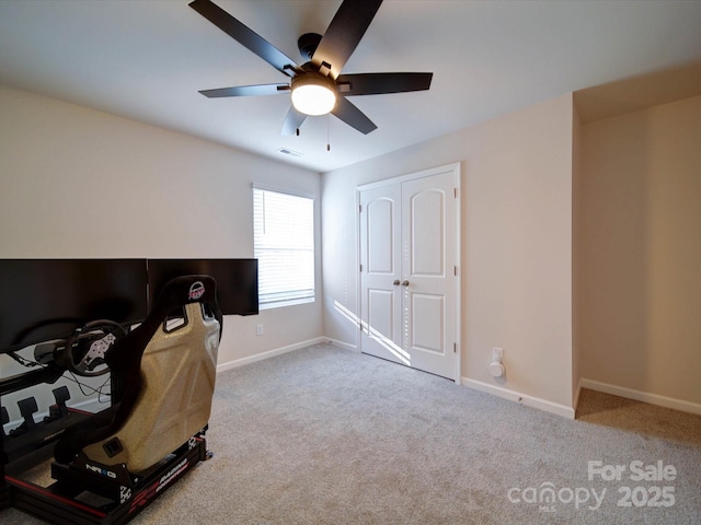 interior space featuring light colored carpet, a closet, and ceiling fan