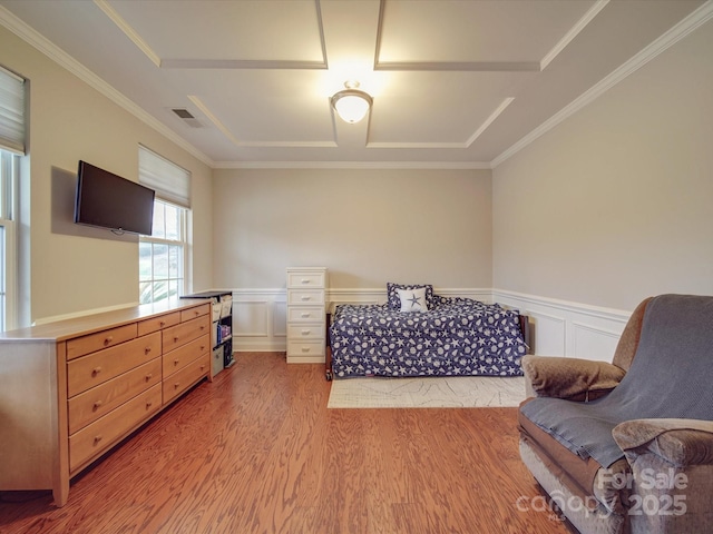 bedroom with crown molding and light hardwood / wood-style floors