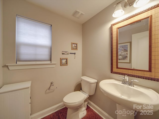 bathroom featuring sink, hardwood / wood-style flooring, and toilet