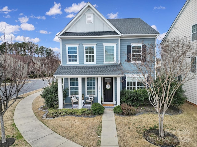 view of front of house with covered porch and a front yard