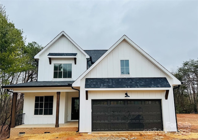 modern farmhouse with a porch and a garage