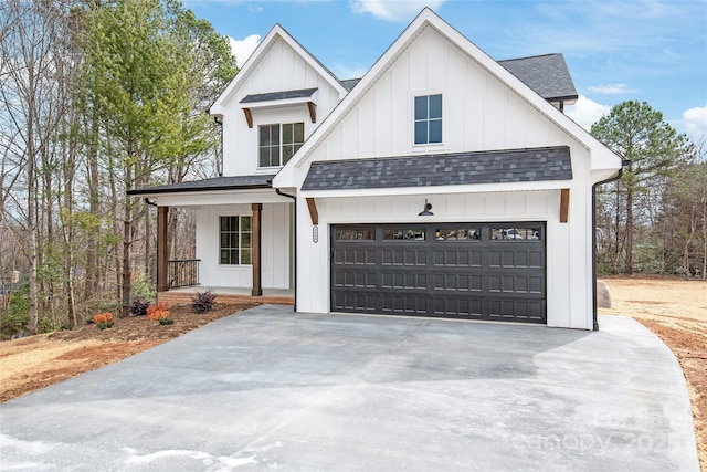 modern farmhouse style home with a porch, board and batten siding, concrete driveway, a shingled roof, and a garage