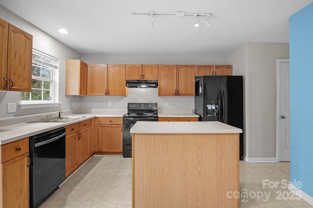 kitchen with sink, light tile patterned floors, black appliances, and a kitchen island