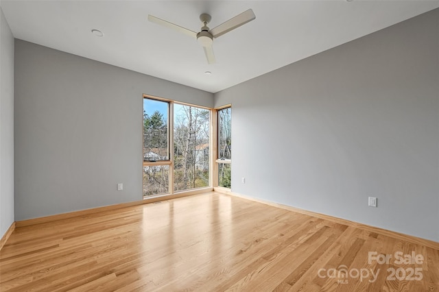 unfurnished room featuring ceiling fan and light hardwood / wood-style flooring