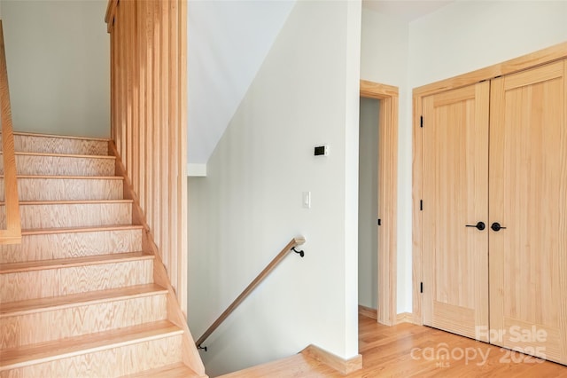 stairs with hardwood / wood-style flooring