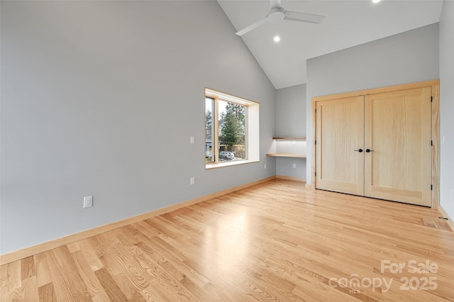 unfurnished bedroom with ceiling fan, high vaulted ceiling, light hardwood / wood-style floors, and a closet