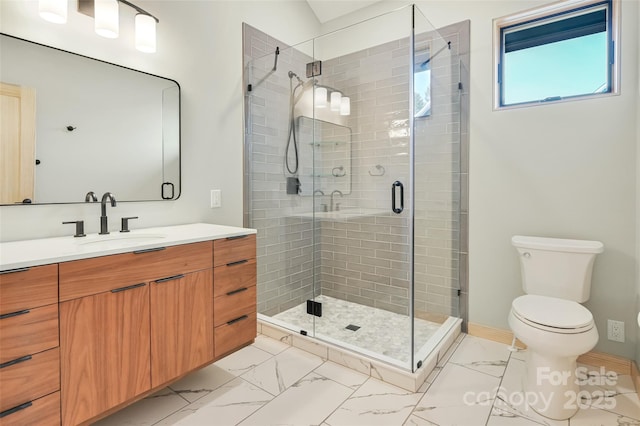 bathroom featuring vanity, an enclosed shower, and toilet