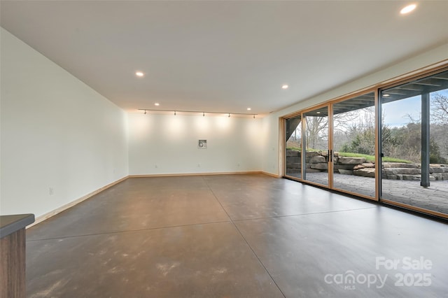 unfurnished room with concrete flooring