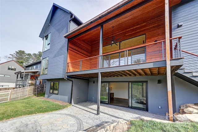 back of property featuring ceiling fan, a balcony, and a patio area