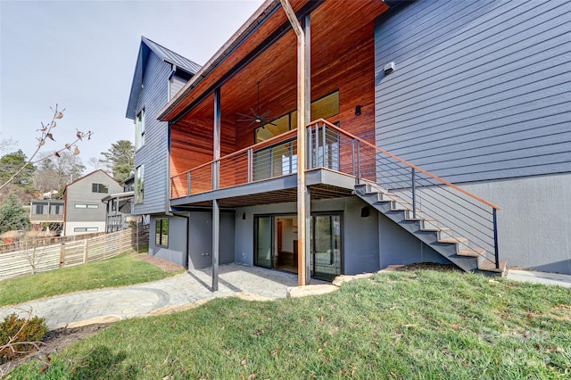 back of house featuring a patio area, ceiling fan, and a lawn