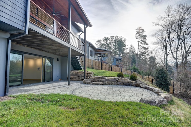 view of yard with ceiling fan and a patio area