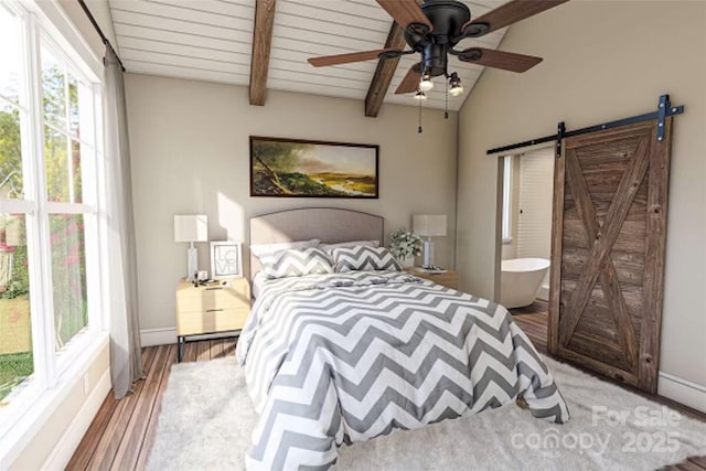 bedroom with ceiling fan, hardwood / wood-style floors, ensuite bathroom, lofted ceiling with beams, and a barn door