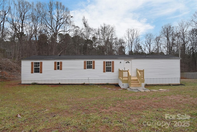 rear view of property featuring a yard