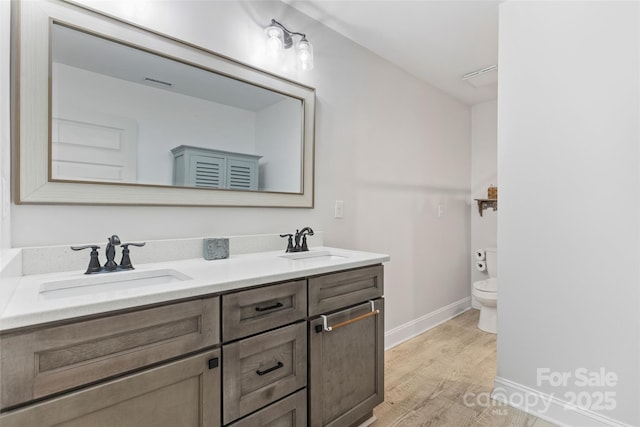 bathroom featuring vanity, toilet, and hardwood / wood-style floors