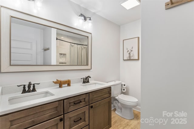 bathroom featuring hardwood / wood-style flooring, vanity, a shower with shower curtain, and toilet