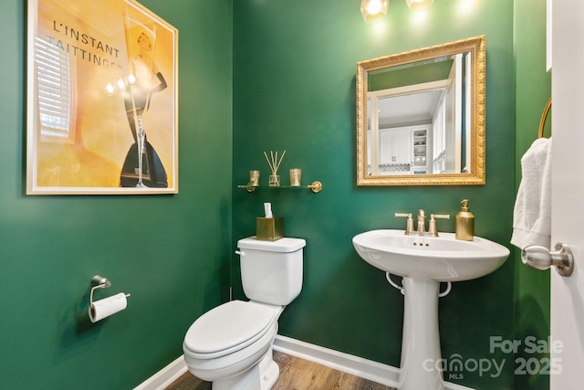 bathroom featuring wood-type flooring and toilet