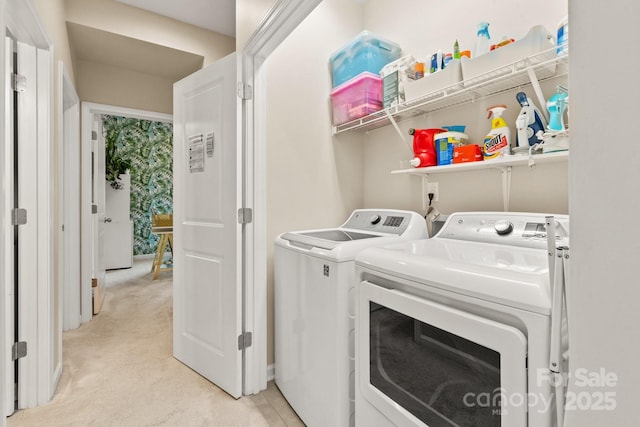 laundry area featuring light colored carpet and separate washer and dryer