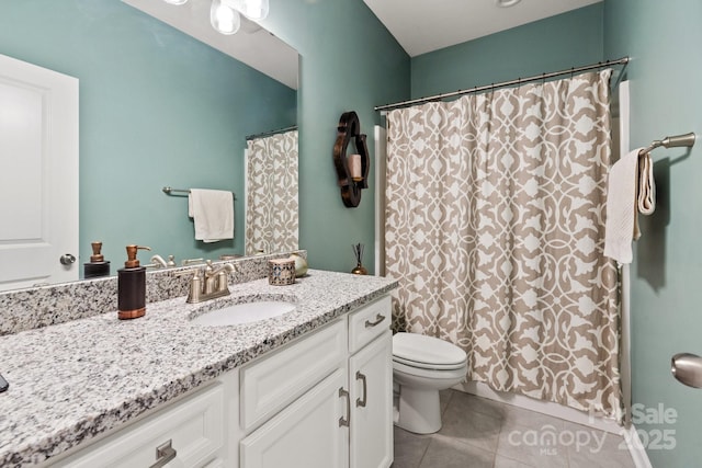 bathroom featuring tile patterned floors, toilet, and vanity