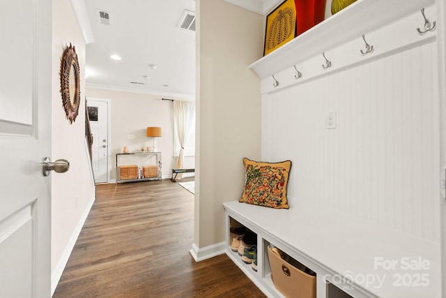 mudroom with ornamental molding and hardwood / wood-style floors