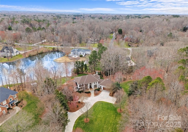 bird's eye view with a forest view and a water view