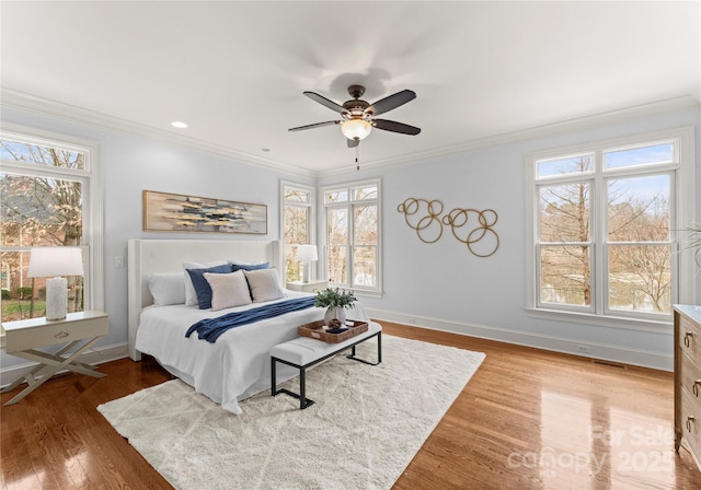 bedroom featuring multiple windows and ornamental molding