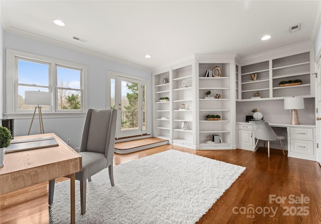 office space featuring visible vents, dark wood finished floors, and crown molding