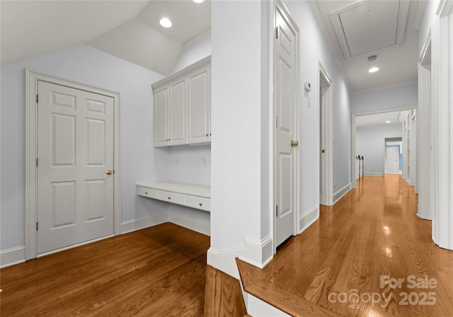 hall featuring recessed lighting, lofted ceiling, light wood-style floors, and attic access