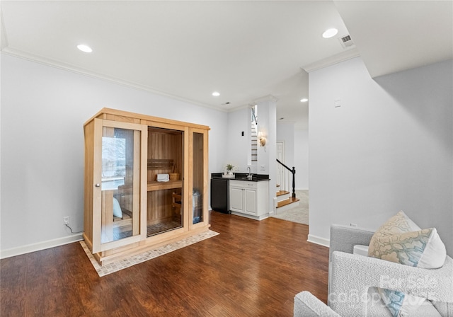 sitting room featuring visible vents, baseboards, ornamental molding, recessed lighting, and dark wood-style flooring