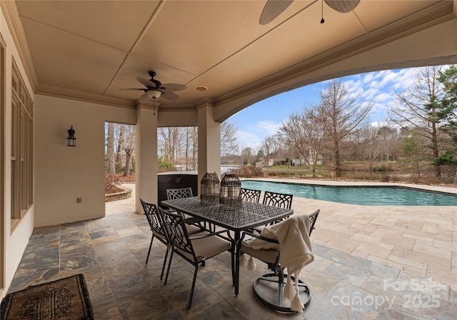 view of patio with outdoor dining area and an outdoor pool