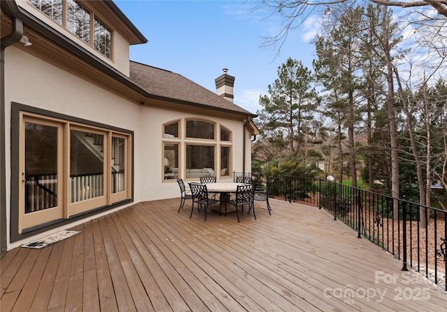 wooden terrace with outdoor dining space