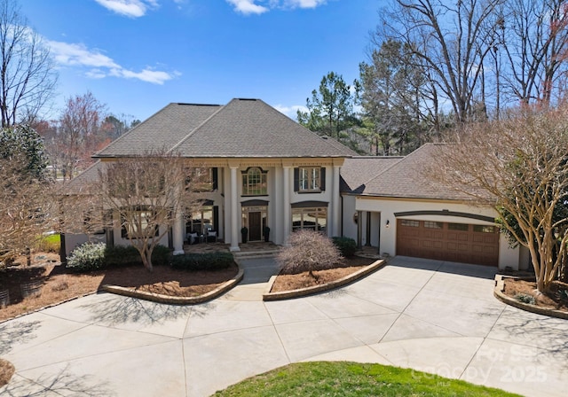 view of front of house featuring stucco siding, concrete driveway, a garage, and a shingled roof