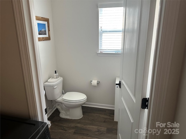 bathroom featuring wood-type flooring and toilet