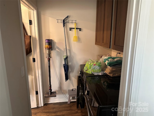 clothes washing area featuring separate washer and dryer and dark hardwood / wood-style floors