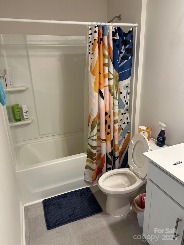 full bathroom with vanity, toilet, tile patterned flooring, and shower / bath combo with shower curtain