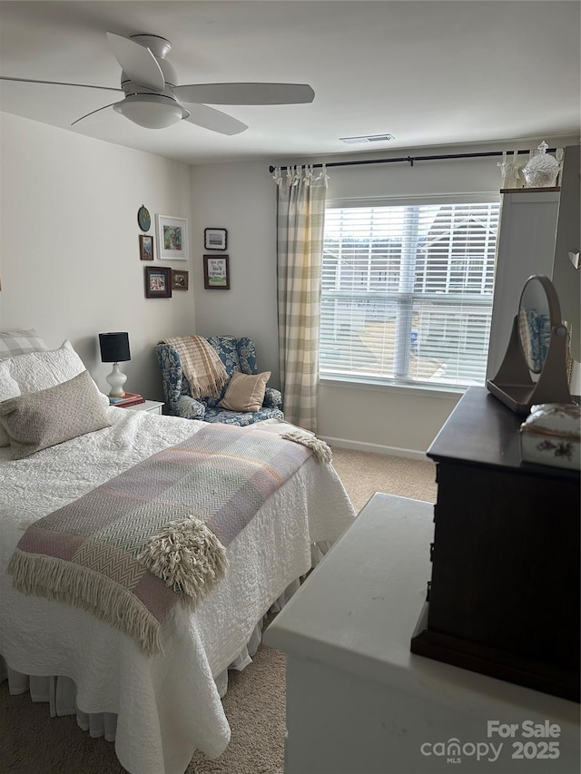 bedroom featuring light carpet and ceiling fan