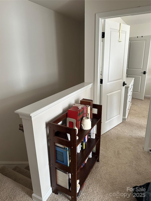 hallway featuring light carpet