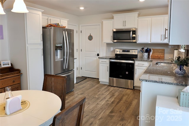 14 Malcolm Ct, Candler, NC 28715 - kitchen with recessed lighting, stainless steel appliances, a sink, and white cabinetry