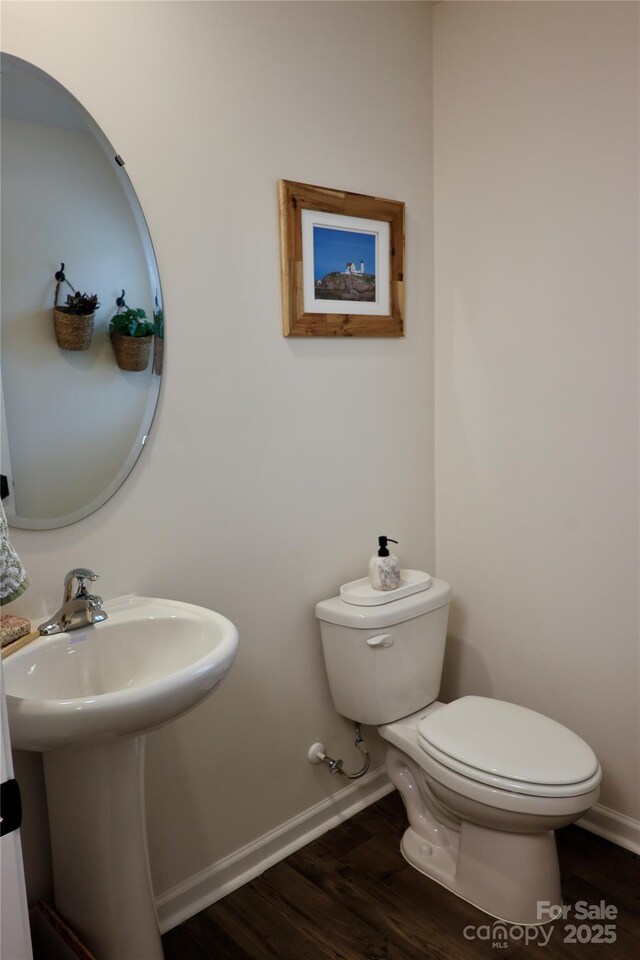 14 Malcolm Ct, Candler, NC 28715 - half bathroom with wood finished floors, toilet, baseboards, and a sink