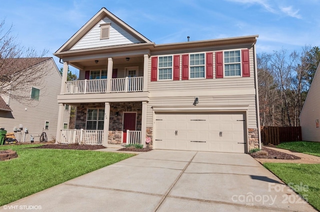 view of front facade featuring a front yard, stone siding, driveway, and a balcony