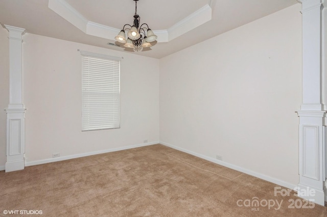 unfurnished room featuring ornamental molding, a raised ceiling, light colored carpet, and ornate columns