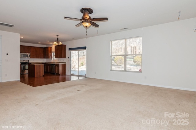 unfurnished living room featuring recessed lighting, visible vents, dark carpet, ceiling fan, and baseboards