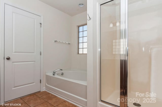 full bathroom with a shower stall, a bath, and tile patterned floors