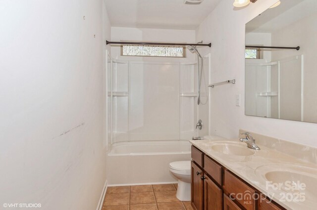 full bath with double vanity, shower / bath combination, toilet, a sink, and tile patterned flooring