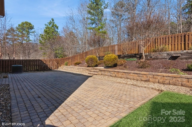 view of patio featuring central AC unit and a fenced backyard