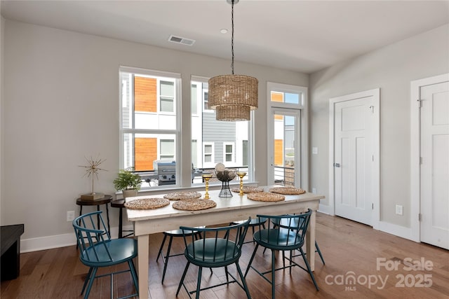 dining area with hardwood / wood-style flooring